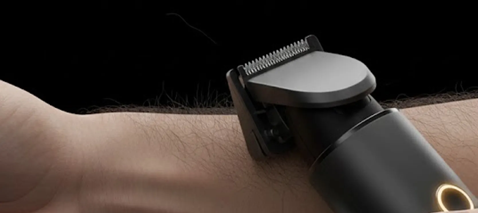 A trimmer gliding over a hairy forearm